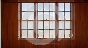 wooden wardrobe doors reflecting window light