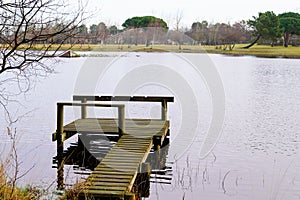 Wooden water bridge pathway boards pontoon to hourtin beach lake