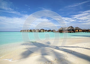 Wooden water bungalows on the tropical beach, Maldives