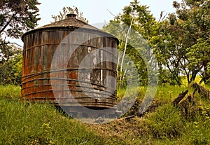 Wooden water tank in rural Hawaiian backcountry photo