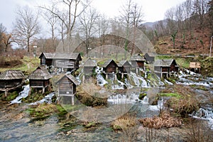 Wooden water mills built on a fast floting river