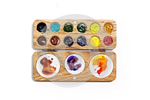 Wooden watercolor palette. Watercolor tray with watercolor set isolated on a white background