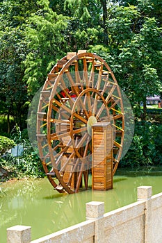 Wooden waterwheel in a pond in rural China