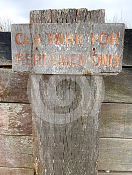 Wooden weathered fisherman parking sign