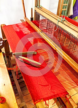 Wooden weaving shuttle on an old manual loom.