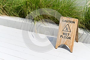 Wooden wet floor caution sign