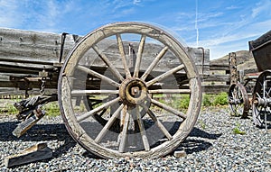 A wooden wheel on an antique horse-drawn wagon