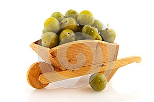 Wooden wheel barrow with plums