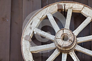 A wooden wheel from an old cart nailed to the wall.