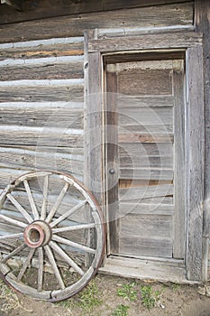 Wooden wheel and old doorway
