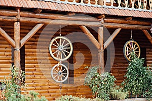 wooden wheels hanging on a rope near the wall