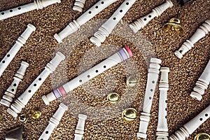 Wooden whistles, brass bells and gingle bells on the grain background