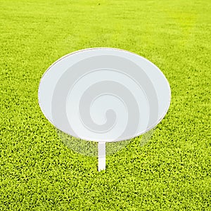 Wooden white blank sign on grass