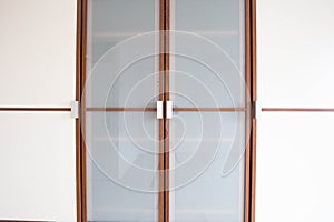 Wooden white closet doors closeup for clothes modern new design