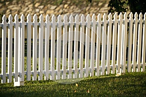 Wooden White Picket Fence At Sunset