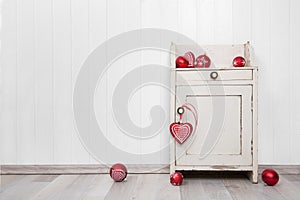 Wooden white wall for a background with red christmas balls.