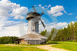 Wooden windmill on background sky with clouds. Naroch lake, Myadel Region, Belarus photo