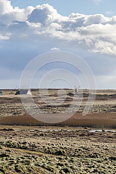 Wooden windmill in a deserted field, old windmill in authentic landscape of island of the Ouessant, Brittany, Finistere, France