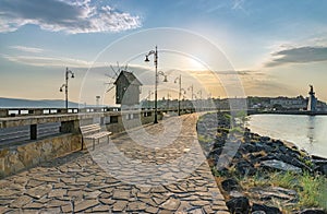 The wooden windmill on the isthmus at sunrise in Nessebar ancient city on the Bulgarian Black Sea Coast. Nesebar or Nesebr is a