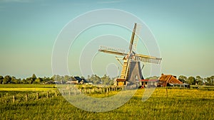 Wooden windmill with miller house vintage look