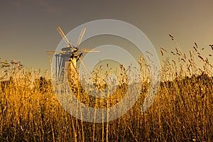 Wooden windmill in sunset