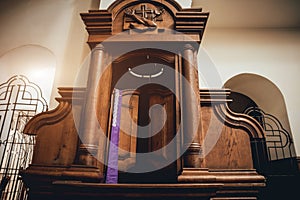 Wooden window of confessional box at church