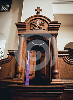 Wooden window of confessional box at church