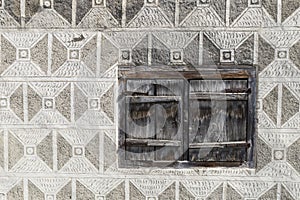 Wooden window with grey graffito wall