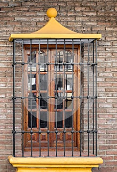 Wooden window with metal grille