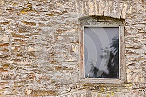 Wooden window in an old stone barn farm building