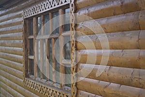 Wooden window with platband. Patterned platband made of wood