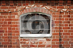 Wooden window in a red brick wall