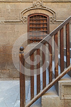 Wooden window and staircase with wooden balustrade leading to historic building, Old Cairo, Egypt photo