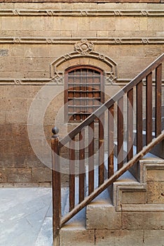 Wooden window and staircase with wooden balustrade leading to historic building, Old Cairo, Egypt photo