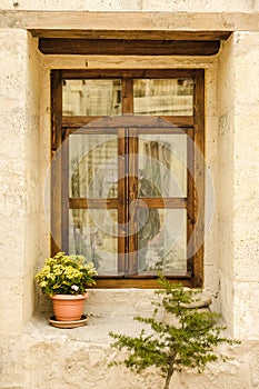 Wooden window on stone wall.