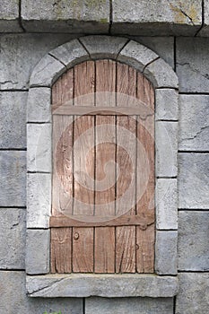 Wooden window in the stone wall