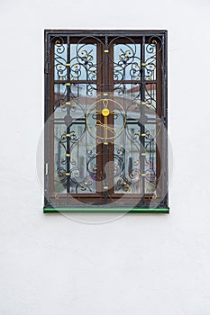 Wooden window with wrough iron cross