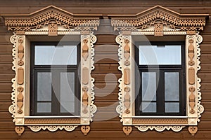 Wooden windows with carved platbands