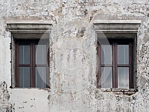 Wooden Windows on the Old White Concrete Wall