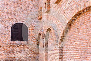 Wooden windows on red brick wall