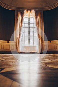 Wooden windows with vintage curtains and square moldings on a sunny day. beige satin curtains. interior of an empty room with