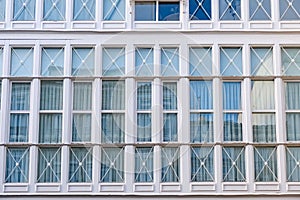 Wooden windows in white in a gallery of a house