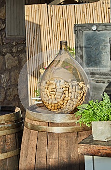 Wooden wine barrel and glass bottle with wine corks, decoration and interior design