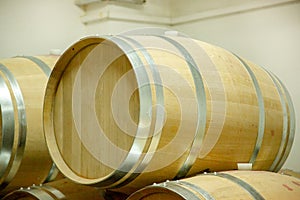 Wooden wine barrels are found at the winery. They are ready to pour or are already filled