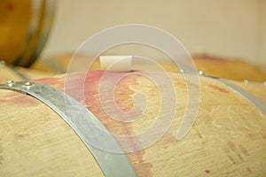 Wooden wine barrels are found at the winery. They are ready to pour or are already filled