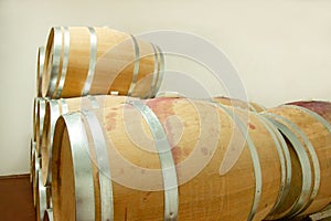 Wooden wine barrels are found at the winery. They are ready to pour or are already filled