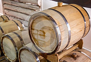 Wooden wine barrels are found at the winery. They are ready to pour or are already filled