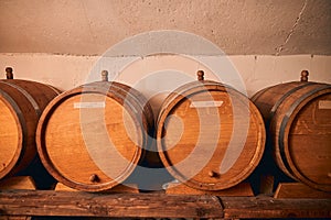 Wooden wine barrels on shelf in storage room