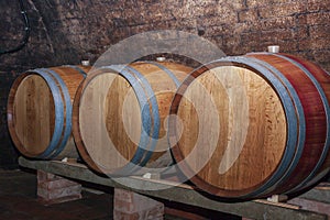 Wooden wine barrels in a wine cellar