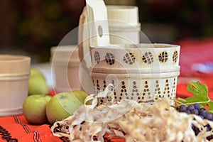 Wooden wine pots and fruits on colorful handmade vintage tablecloth